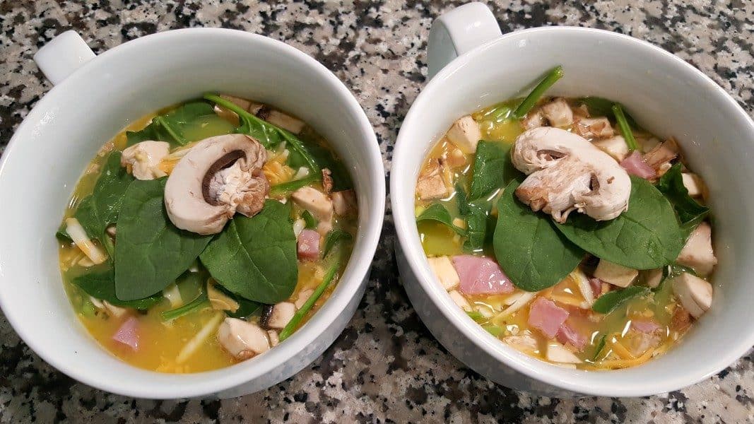 eggs, milk, salt, ham, spinach, mushrooms, cheese, and green onion mixed together poured into two baking dishes