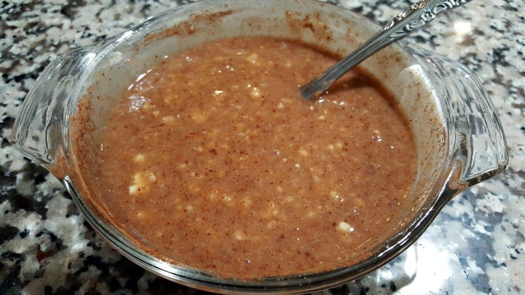 korma curry ingredients mixed together in a bowl with a spoon