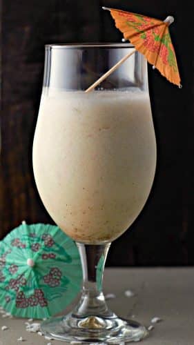 Piña Colada in a stemmed beer glass with a drink umbrella