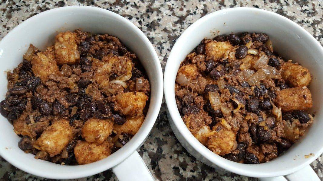 ground beef, black beans, tater tot, and colby jack cheese mixture pressed into two baking dishes