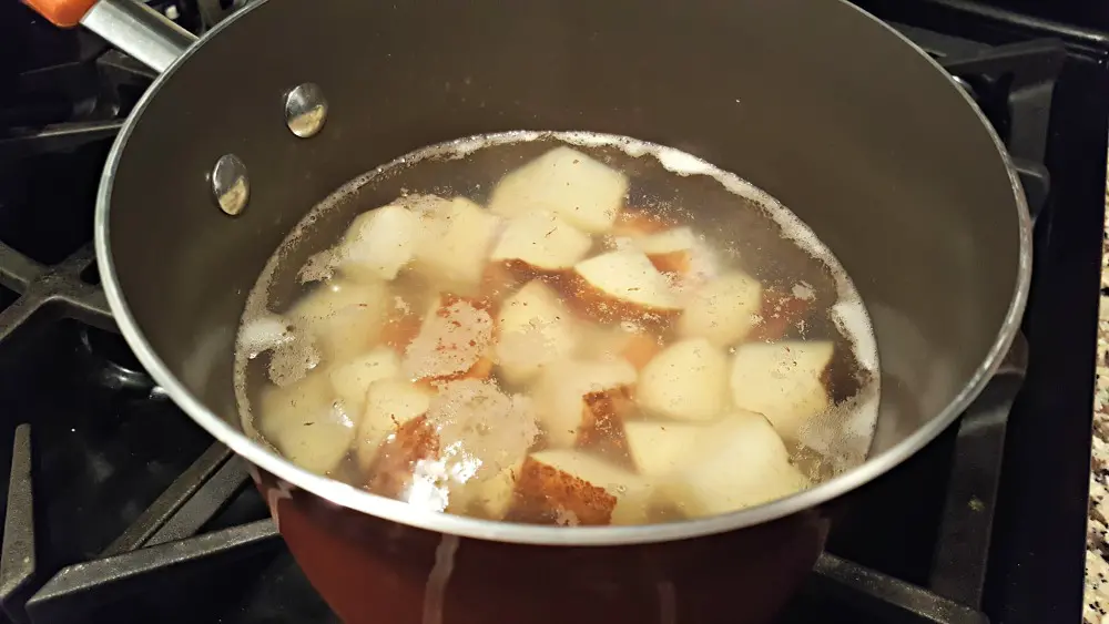 potatoes boiling in a pan for mashed potato casserole
