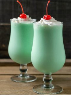 two mint shakes in tall glasses.