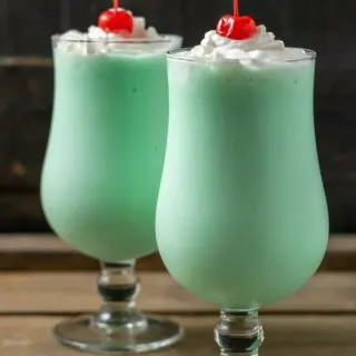 two mint shakes in tall glasses.