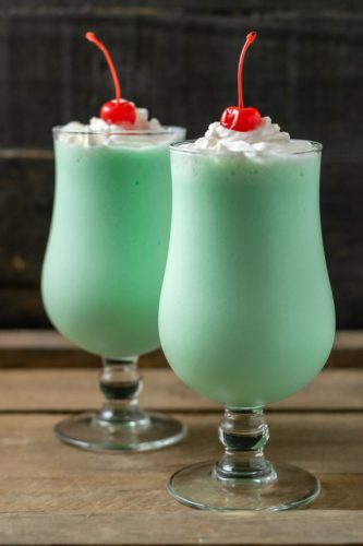 two mint shakes in tall glasses.