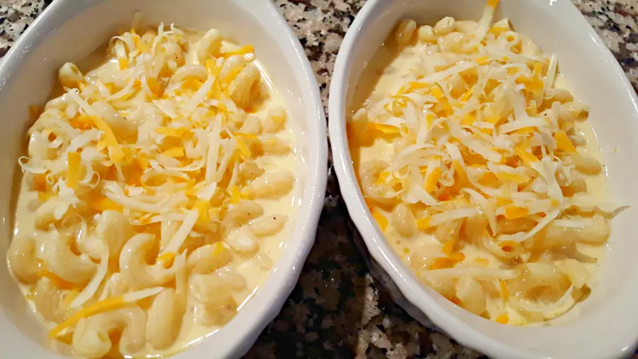 mac and cheese without flour topped with shredded cheese ready to go in the oven