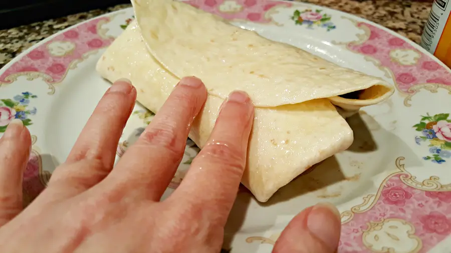 Showing how to fold the tortilla for Crispy Chicken Chimichangas