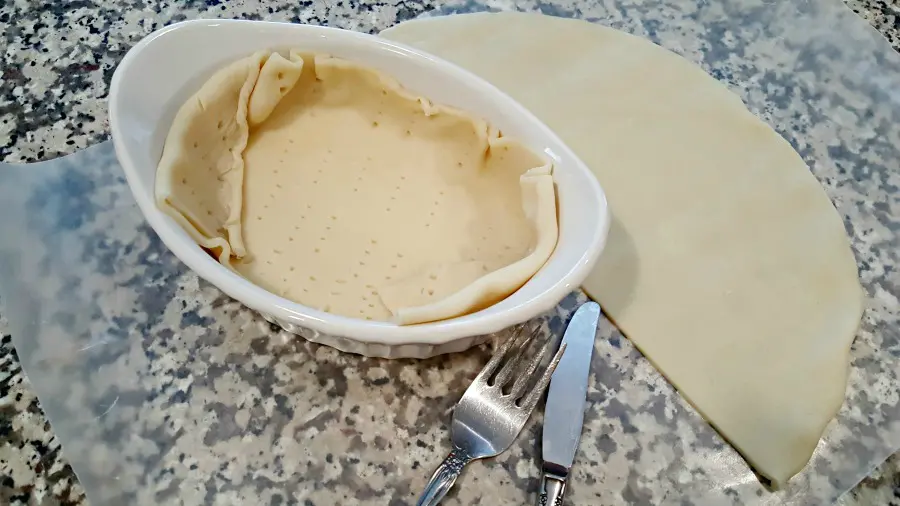 placing the pie crust in the baking dishes
