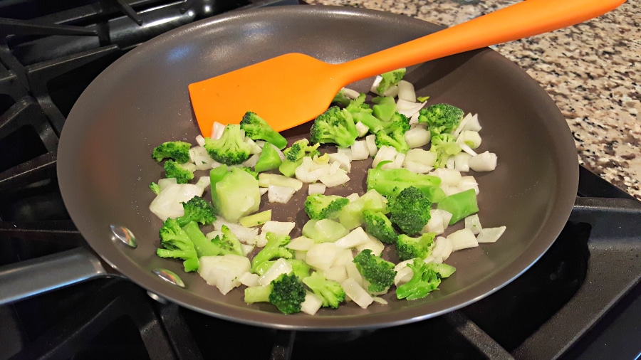 onion and broccoli in a frying pan