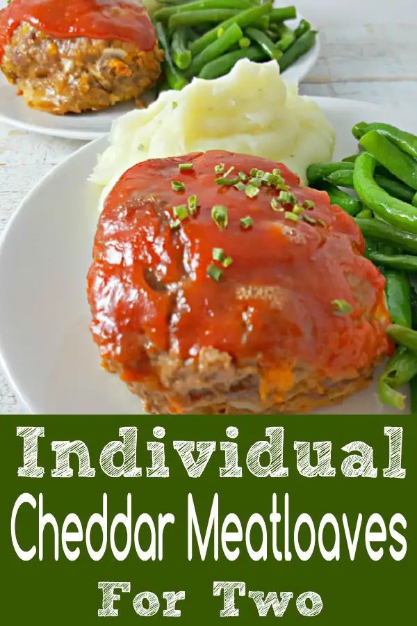 Individual Cheddar Meatloaves on two plates.