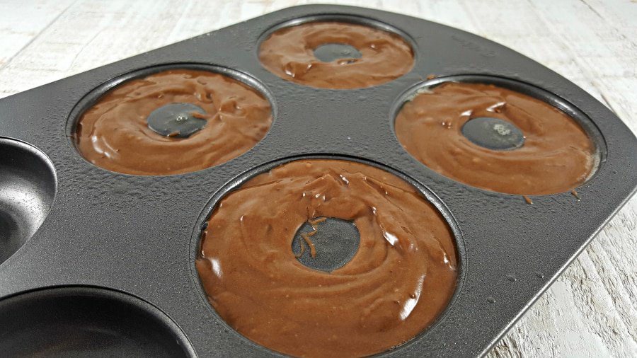 chocolate batter in a donut pan ready to bake.