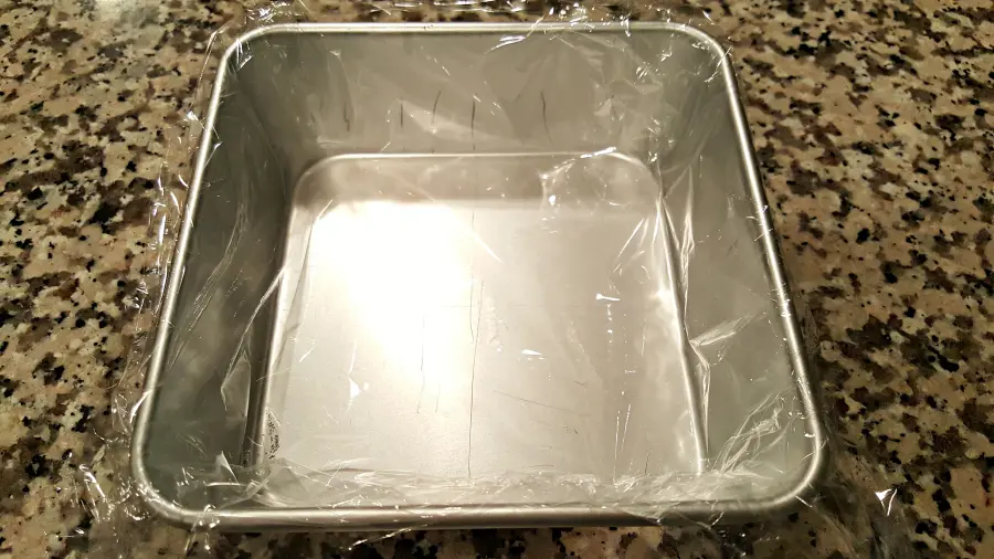 6 inch cake pan lined with plastic wrap
