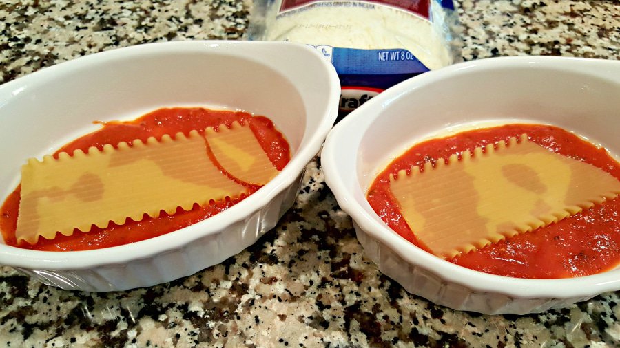 sauce and half noodles in two baking dishes