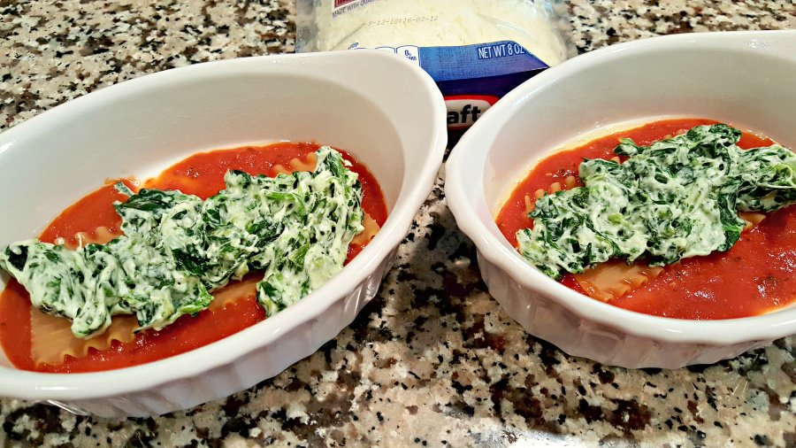 sauce, half a noodle, and spinach and cheese mix in two baking dishes