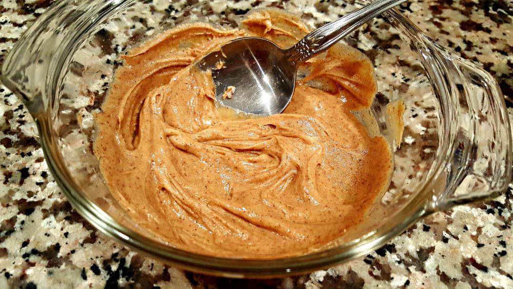 peanut butter lava cake sauce in a bowl with a spoon