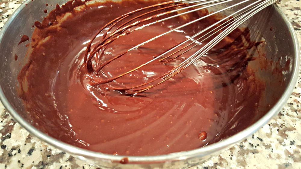 chocolate lava cake batter in a bowl with a whisk