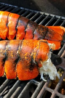 Lobster Tails cooking on a grill.