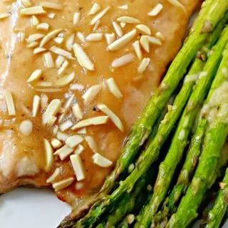 Honey Dijon Almond Salmon and Asparagus on a plate.