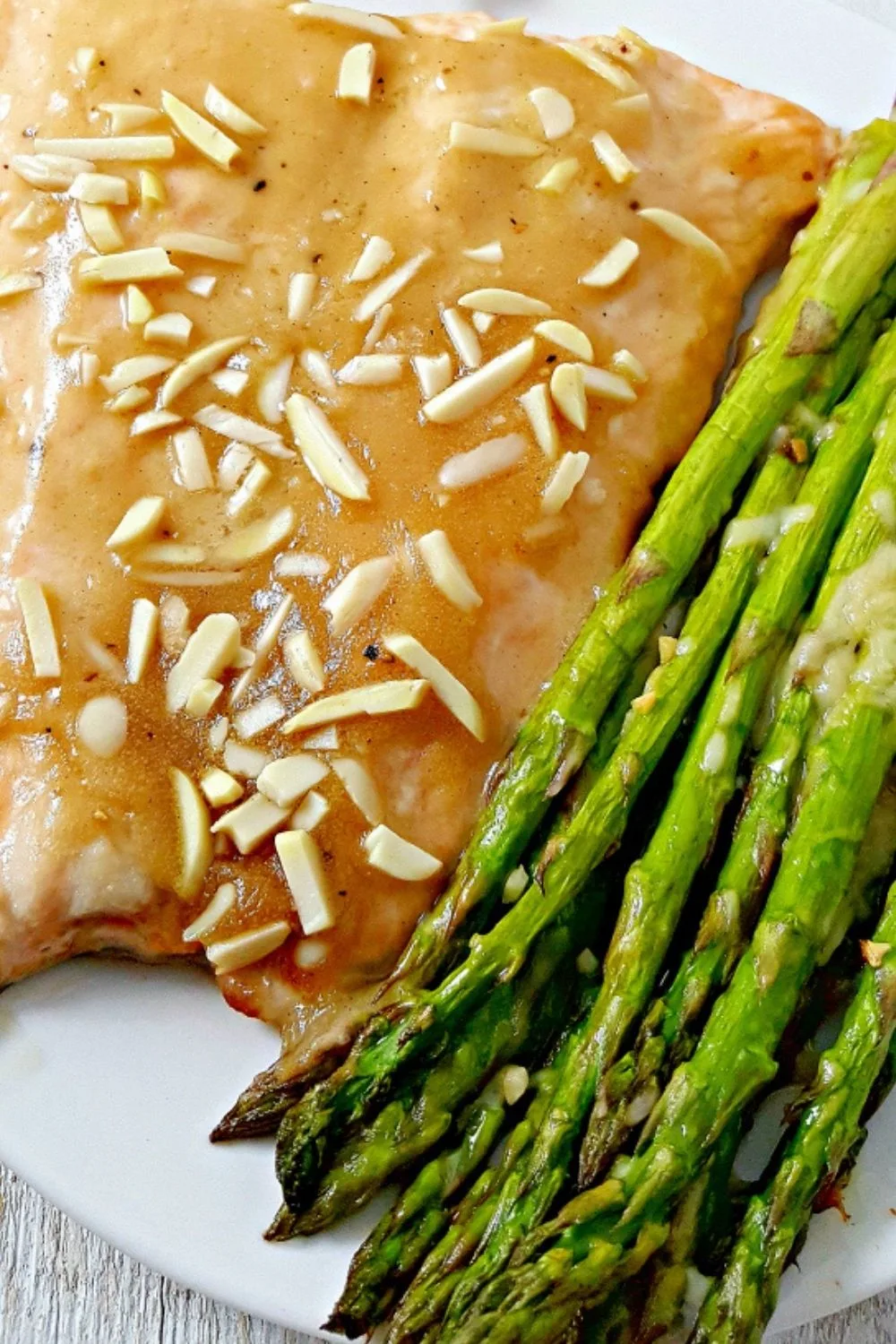 Honey Dijon Almond Salmon and Asparagus on a plate.