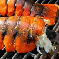 Lobster Tails cooking on a grill.