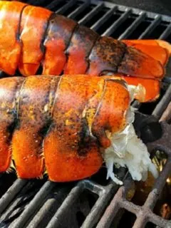 Lobster Tails cooking on a grill.