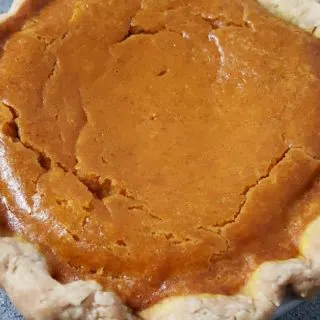 a small Pumpkin Pie in a small pie pan.