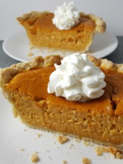 Small Pumpkin Pie slices on two plates.