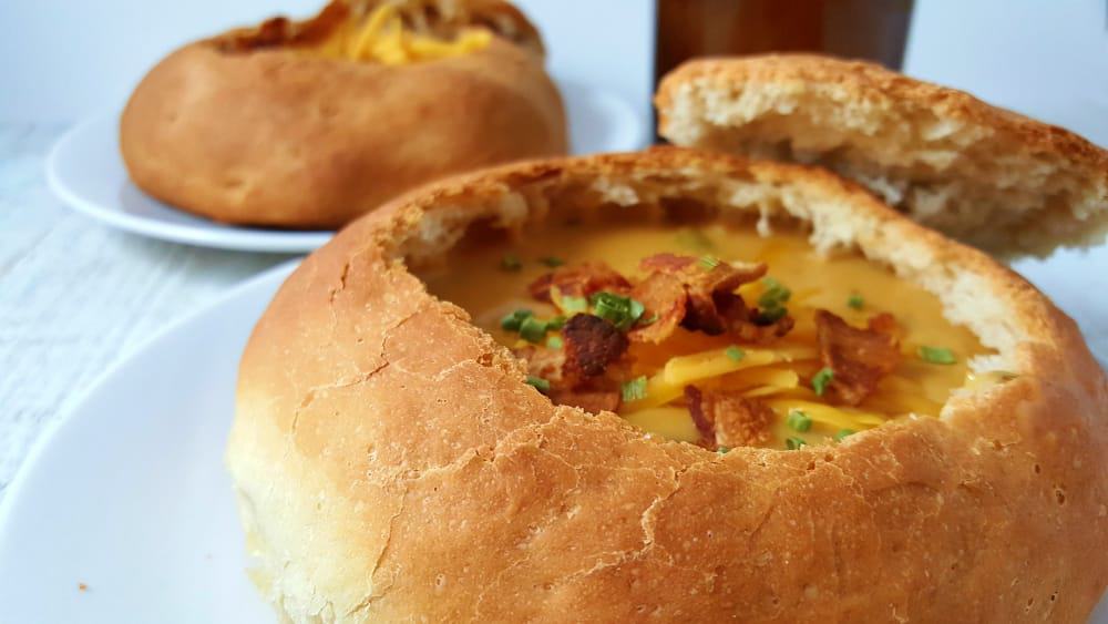 Cheddar Beer Soup in two bread bowls