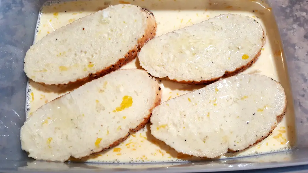4 slices of egg soaked bread in a dish