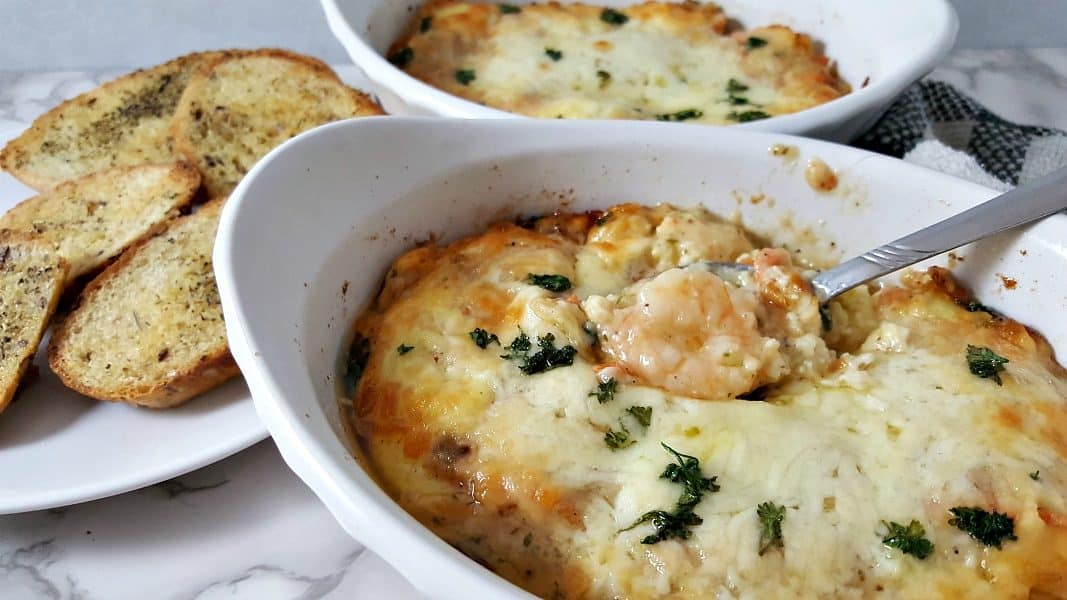 Cheesy Shrimp Scampi Lasagna casserole in two dishes with a side of garlic bread