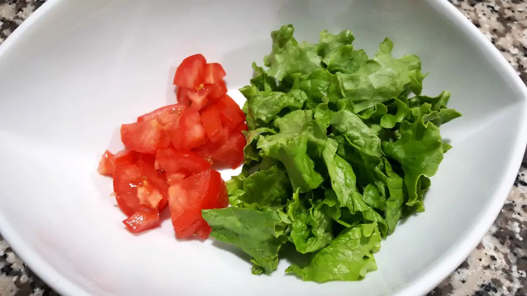 diced tomato and chopped lettuce in a large bowl.
