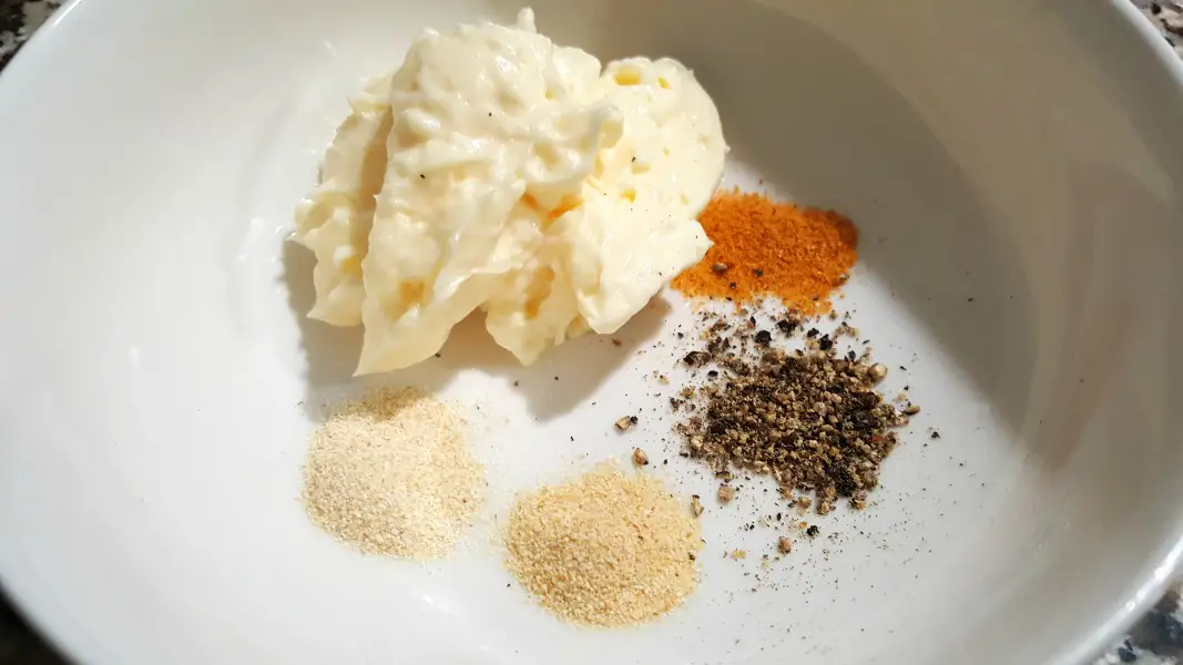 mayo, pepper, seasoned salt, garlic powder, and onion powder in a bowl.