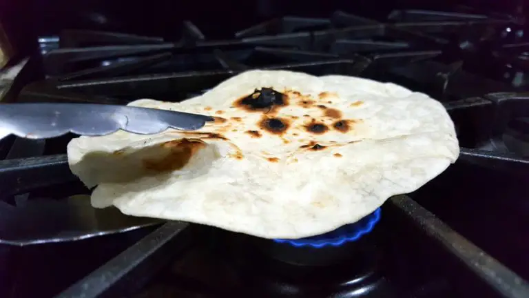 flour tortilla cooking over an open flame.