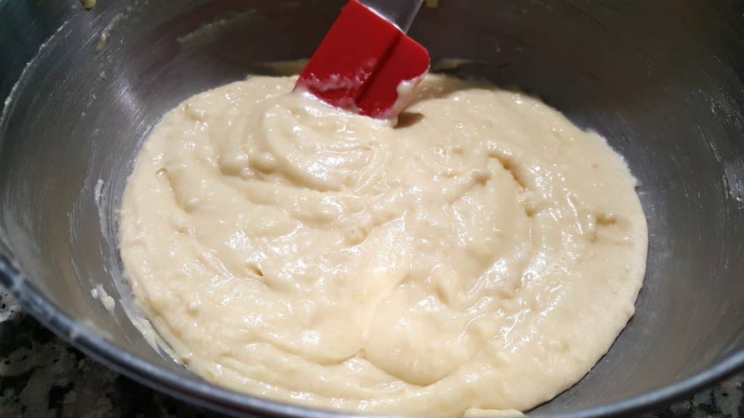 a bowl with flour, sugar, butter, milk, egg, baking powder, and salt mixed together