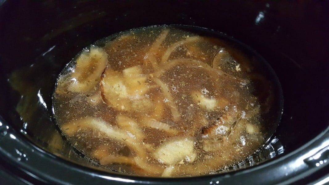 onions, seasonings, and broth in a crockpot