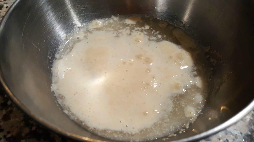 yeast, sugar, and water activating in a bowl