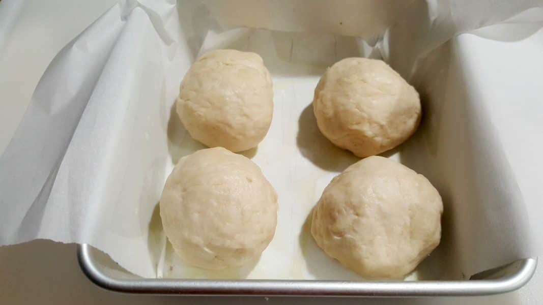 four dough balls into cake pan