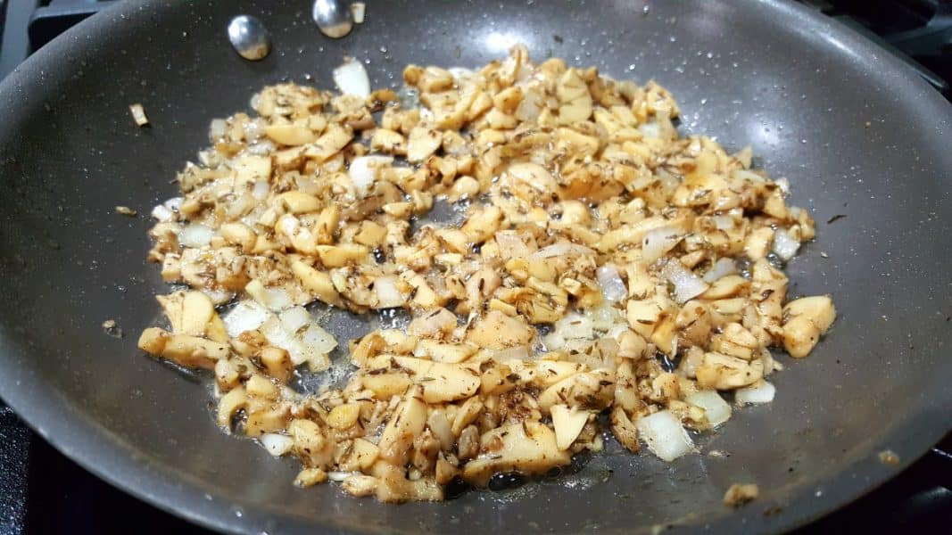 mushroom and onion mixture cooking in a pan