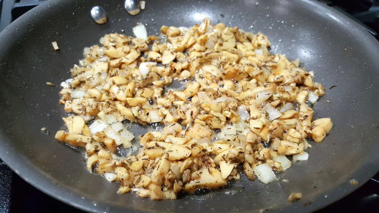 mushroom and onion mixture cooking in a pan.