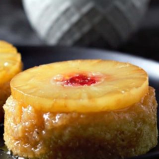 Individual Pineapple Upside-down Cakes on plates.