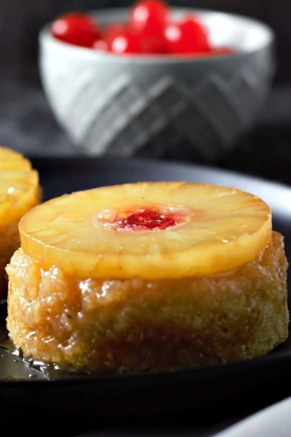 Individual Pineapple Upside-down Cakes on plates.