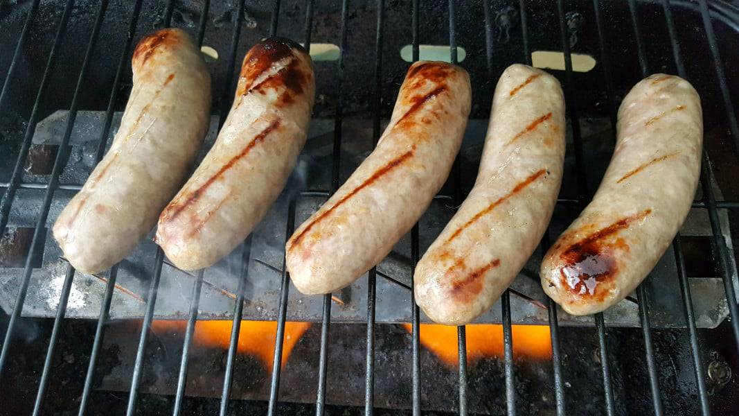five Brats on the Grill cooking.