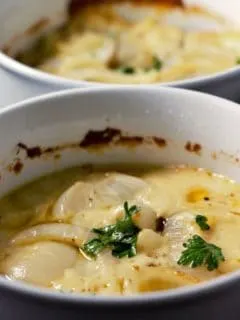 Creamy Au Gratin Potatoes in two casserole dishes.