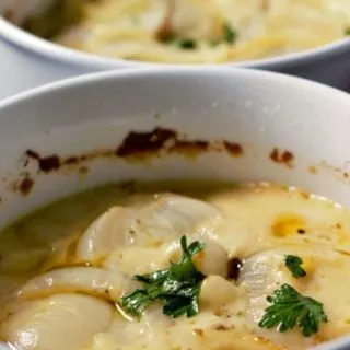 Creamy Au Gratin Potatoes in two casserole dishes.