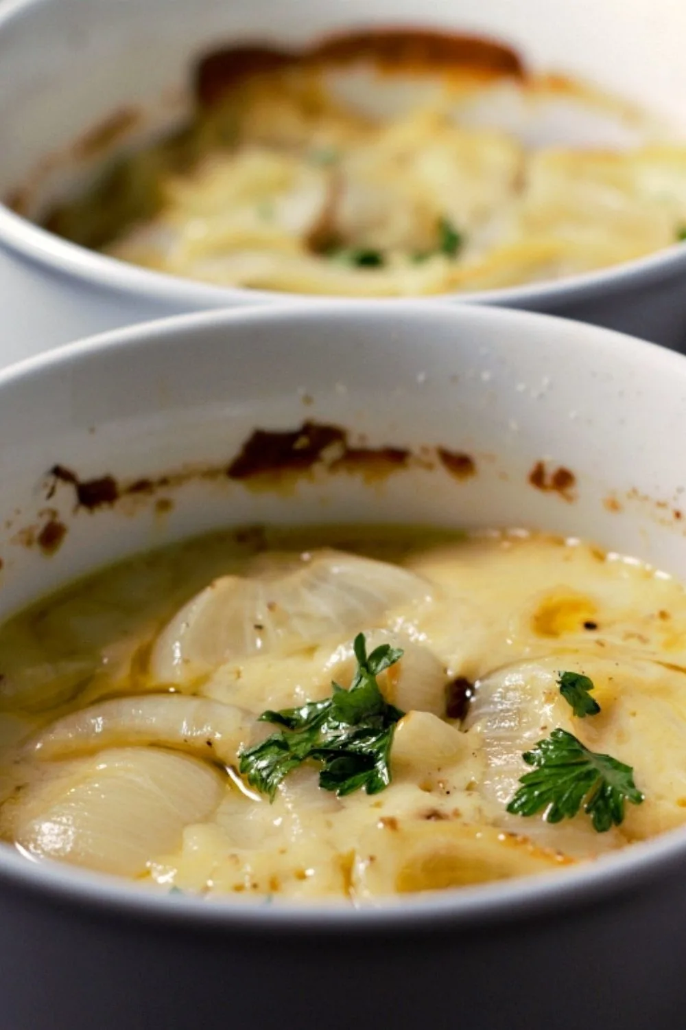 Creamy Au Gratin Potatoes in two casserole dishes.