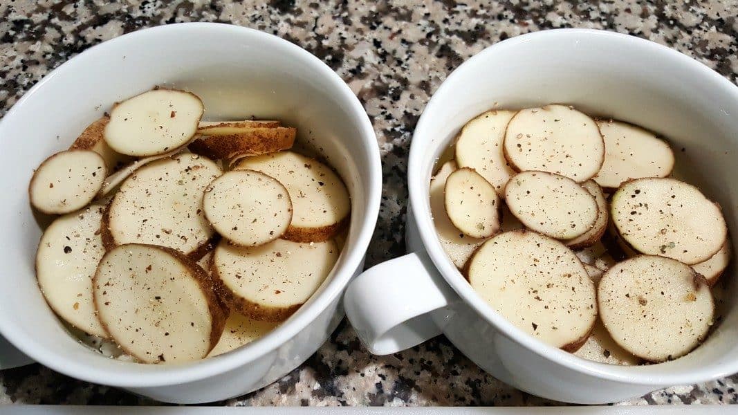 two bowls with sliced potatoes sprinkled with black pepper