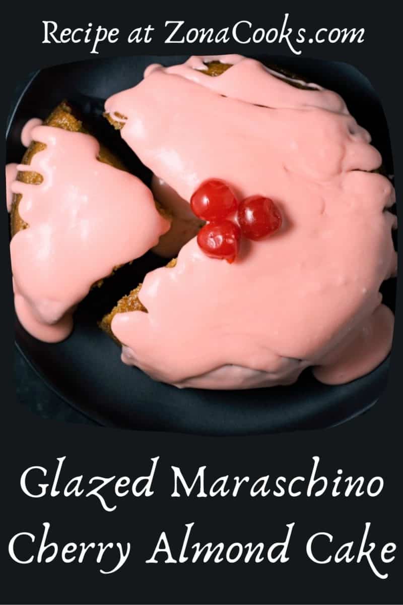 Moist Cherry and Almond Cake with one slice cut and pulled away.