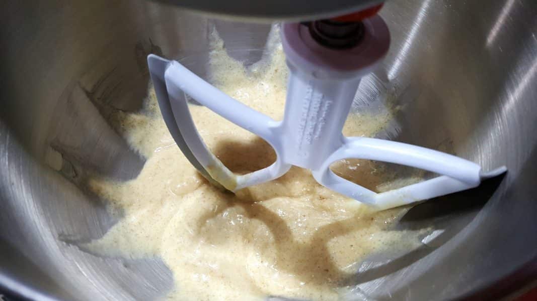cake batter mixed together in a stand mixer bowl with paddle attachment