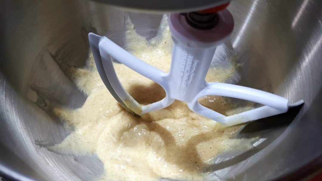 cake batter mixed together in a stand mixer bowl with paddle attachment.