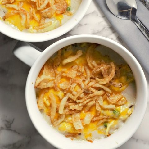 a top view of baked tuna noodle casserole in two dishes with a spoon