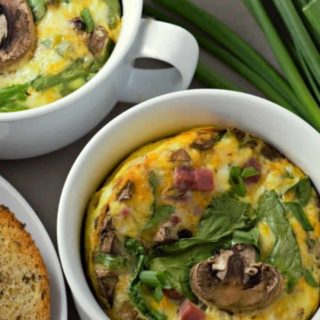 Baked Cheesy Ham Spinach Omelets in two casserole dishes.